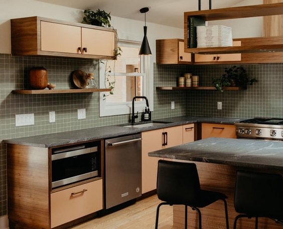 Modern kitchen with dark stone countertops and warm wood cabinetry