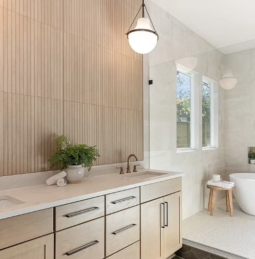 Bathroom vanity countertop with light cabinetry and wall tile