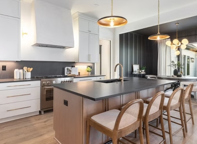 Large kitchen island with dark countertop and seating
