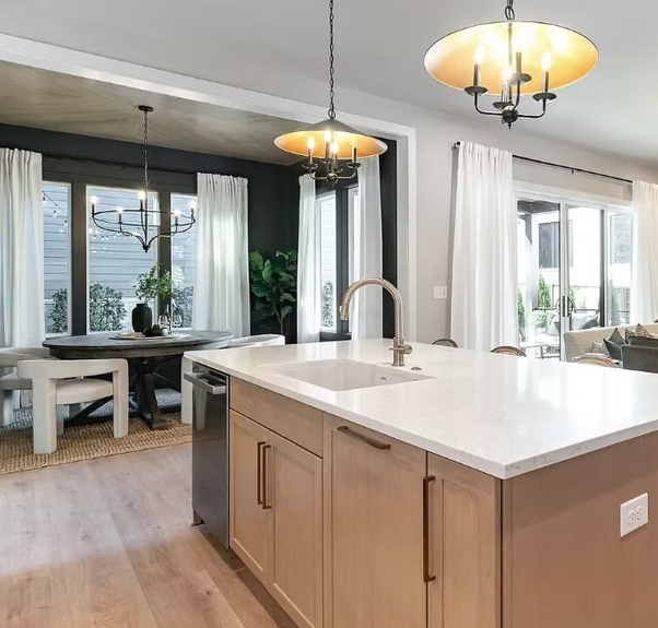 White kitchen island countertop beside an open dining area
