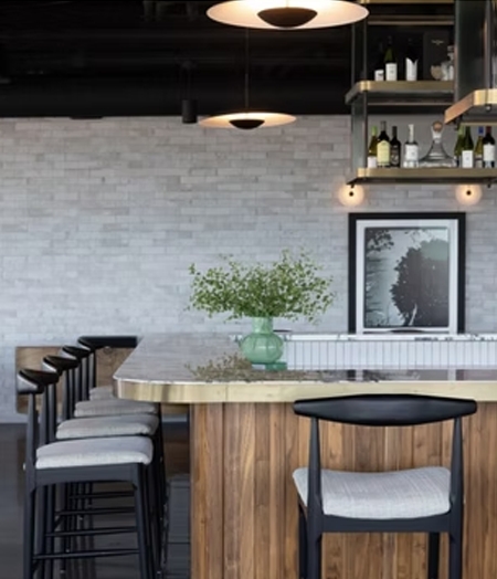 Bar seating with a light countertop and wood island base