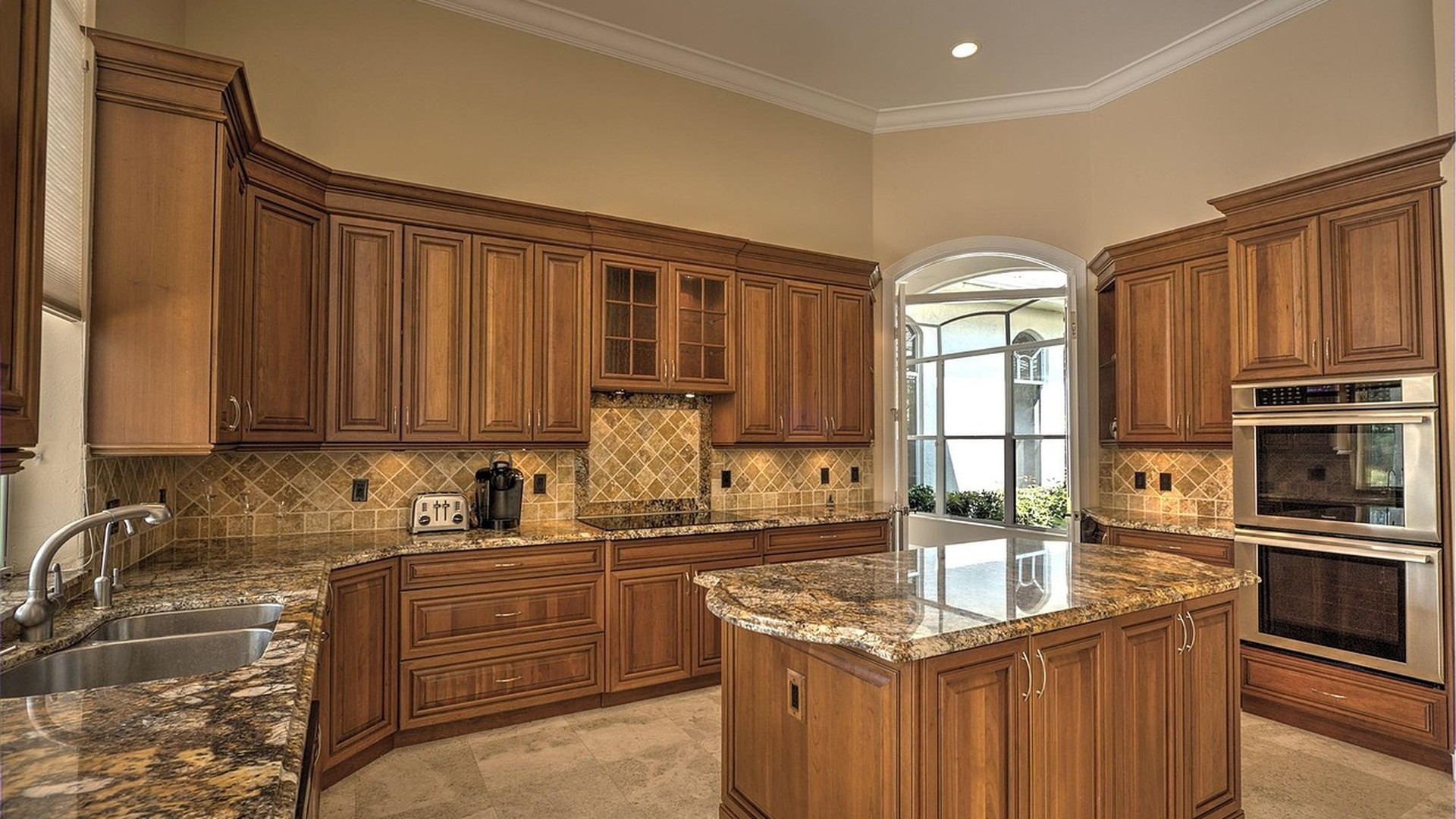 Luxury kitchen with dramatic natural granite countertops and matching island in a US home